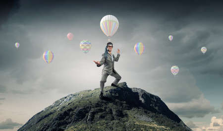 Cheerful young businessman with tie around headの写真素材