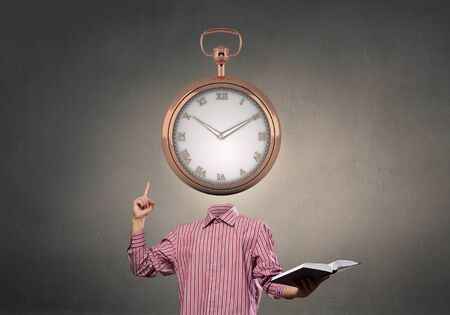 Businessman with alarm clock instead of his headの写真素材