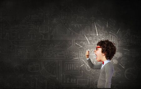 Funny young man with big head screaming emotional in mobile phoneの写真素材