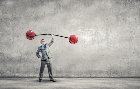 Confident businessman lifting above head sketched barbellの写真素材