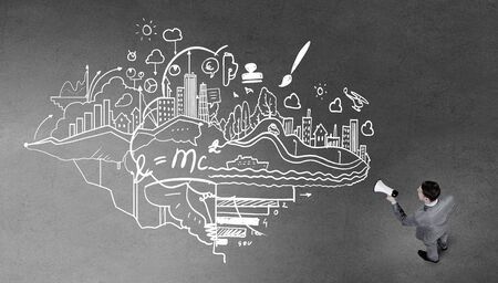 Top view of businessman screaming in megaphoneの写真素材