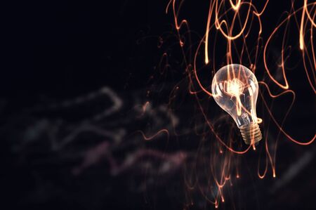 Glowing glass light bulb on dark bakgroundの写真素材