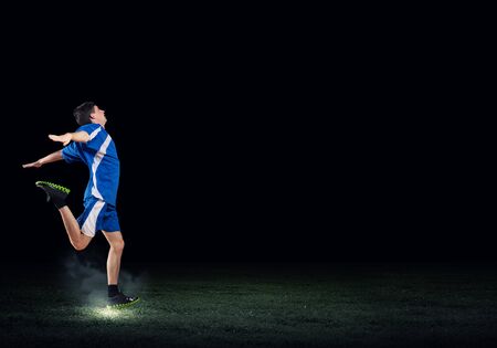 Running man in blue sport wear on black backgroundの写真素材