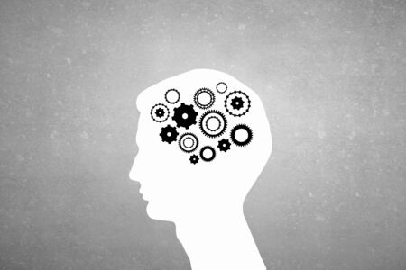Silhouette of human head with gears mechanism instead of brainの写真素材