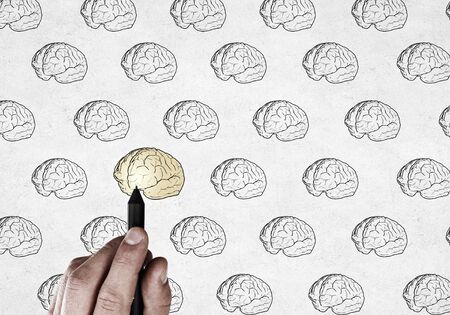 Close up of businessman drawing human brain on screenの写真素材