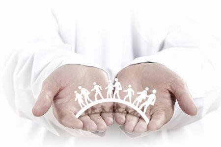 Close up of human hands with row of people figures