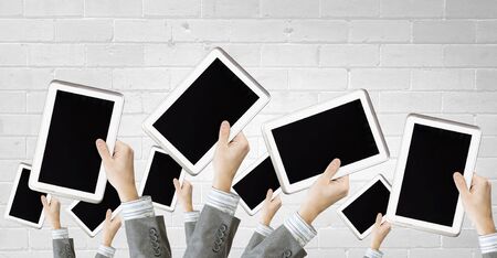 Team of business people holding tablets in handsの写真素材