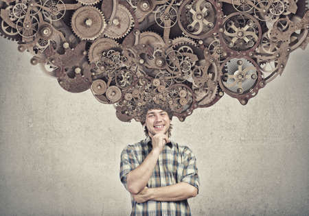 Thoughtful guy with gear mechanisms above his headの写真素材