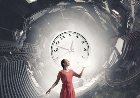 Young woman in red dress with book in handの写真素材