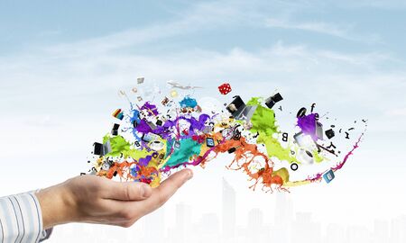 Male hands and paint splashes and icons in palmsの写真素材