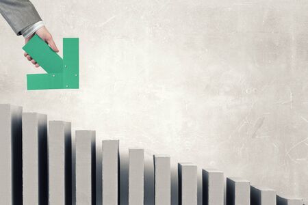 Hand of businessman holding green arrow pointing directionの写真素材