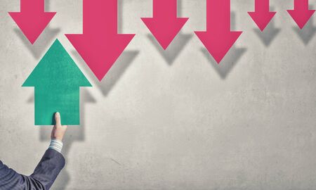 Hand of businessman holding green arrow pointing directionの写真素材