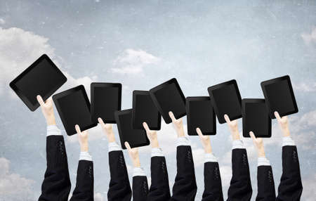 Team of business people holding tablets in handsの写真素材