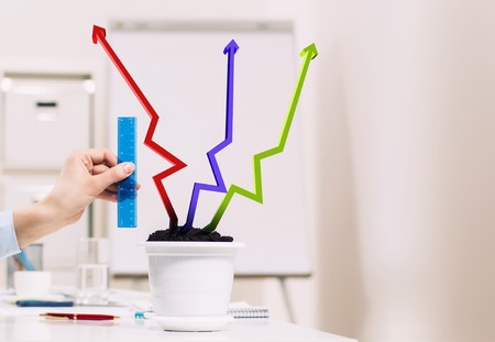 Plant in pot shaped like graph. Wealth conceptの写真素材