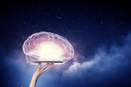Hand holding metal tray with human brain symbolの写真素材