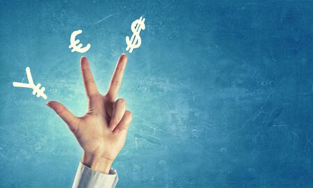 Hands and money currency signs on fingersの写真素材