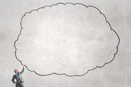 Young businessman holding speech cloud above head. Place for your text