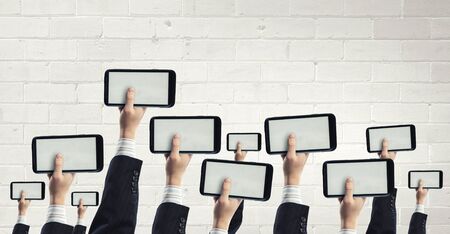 Team of business people holding tablets in handsの写真素材