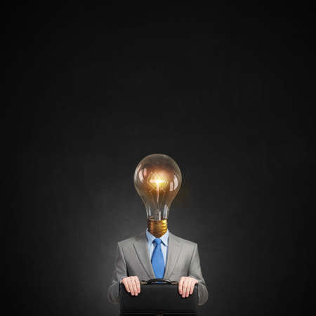 Unrecognizable businessman with light bulb instead of headの写真素材