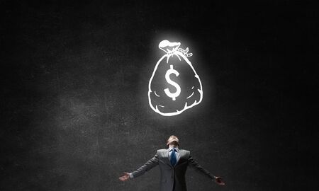 Businessman with hands spread apart and money sign aboveの写真素材