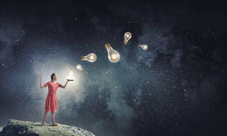 Young woman in red dress with book in handの写真素材