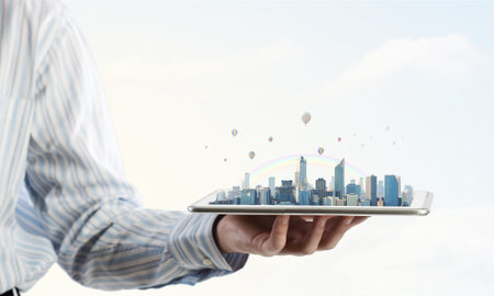 Hand holding tablet computer with cityscape on screen