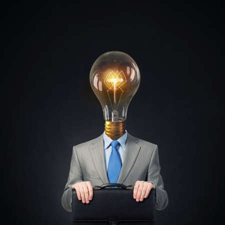 Unrecognizable businessman with light bulb instead of headの写真素材