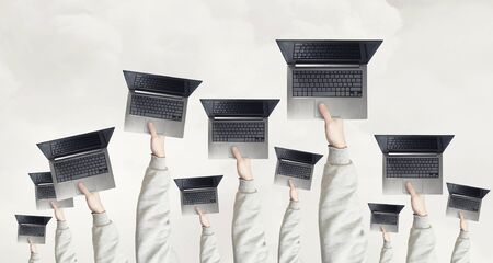 Many business people holding in hands laptopsの写真素材