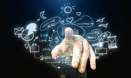 Male hand pointing with finger at business plan on screenの写真素材