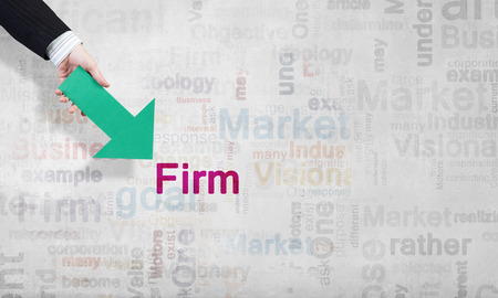 Businessman hand pointing with arrow on word FIRMの写真素材