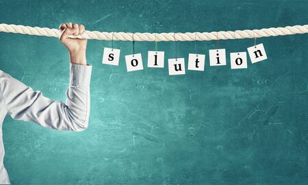 Word solution composed of cards hanging on ropeの写真素材