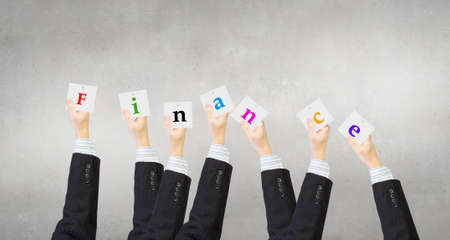 Group of business people holding in hands cards with lettersの写真素材