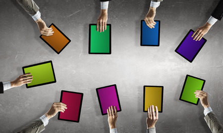 Team of business people holding tablets in handsの写真素材