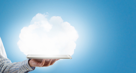 Tablet pc in hands of businessman and cloud conceptの写真素材