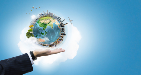Close up of male hand holding our Earth planet. Elements of this image are furnished by NASAの写真素材