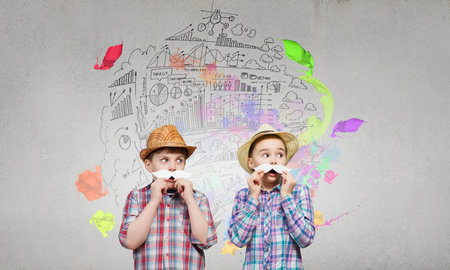 Cute girl and boy wearing shirt hat and mustacheの写真素材