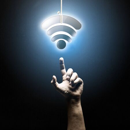 Person hand pointing with finger at glowing iconの写真素材