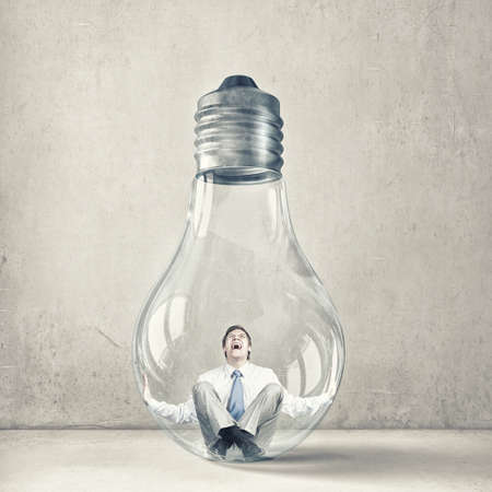 Screaming businessman trapped inside of light bulbの写真素材