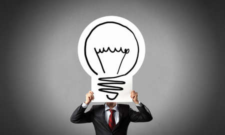 Unrecognizable businessman holding light bulb paper conceptの写真素材