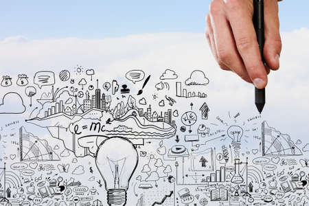 Person hand drawing business strategy plan on sky backgroundの写真素材