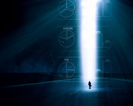 Rear view of businessman standing in light going from above