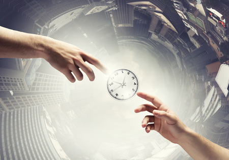 Close up of man hand pointing at clock watch symbolの写真素材