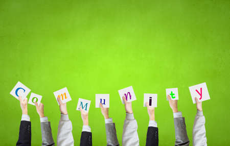 Group of business people holding in hands cards with lettersの写真素材