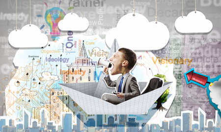 Businessman escapes from the crisis on a paper boatの写真素材