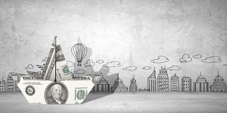 Ship made of dollar banknote floating in waterの写真素材