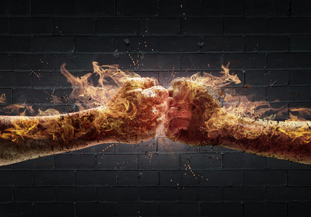 Close up of two fists in fire hitting each otherの写真素材