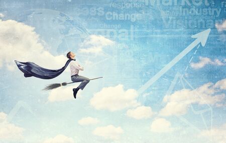 Young businessman flying on broom and growth conceptの写真素材