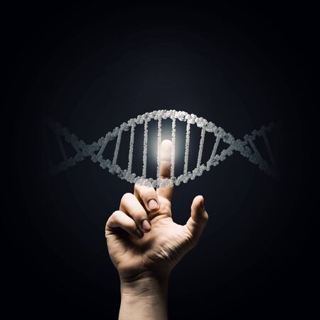 Science concept image of human hand touching DNA moleculeの写真素材
