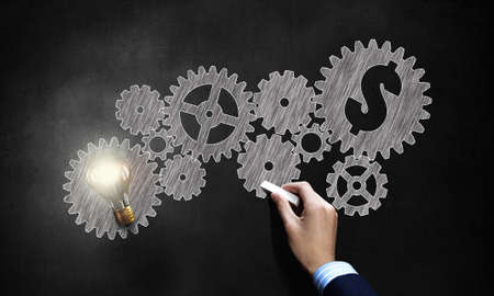 Conceptual image of gears and cogwheels drawn with chalkの写真素材