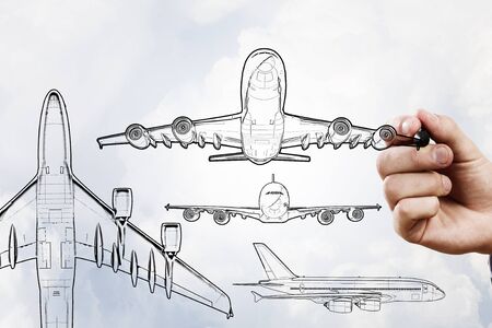 Person drawing airplane model on sky backgroundの写真素材